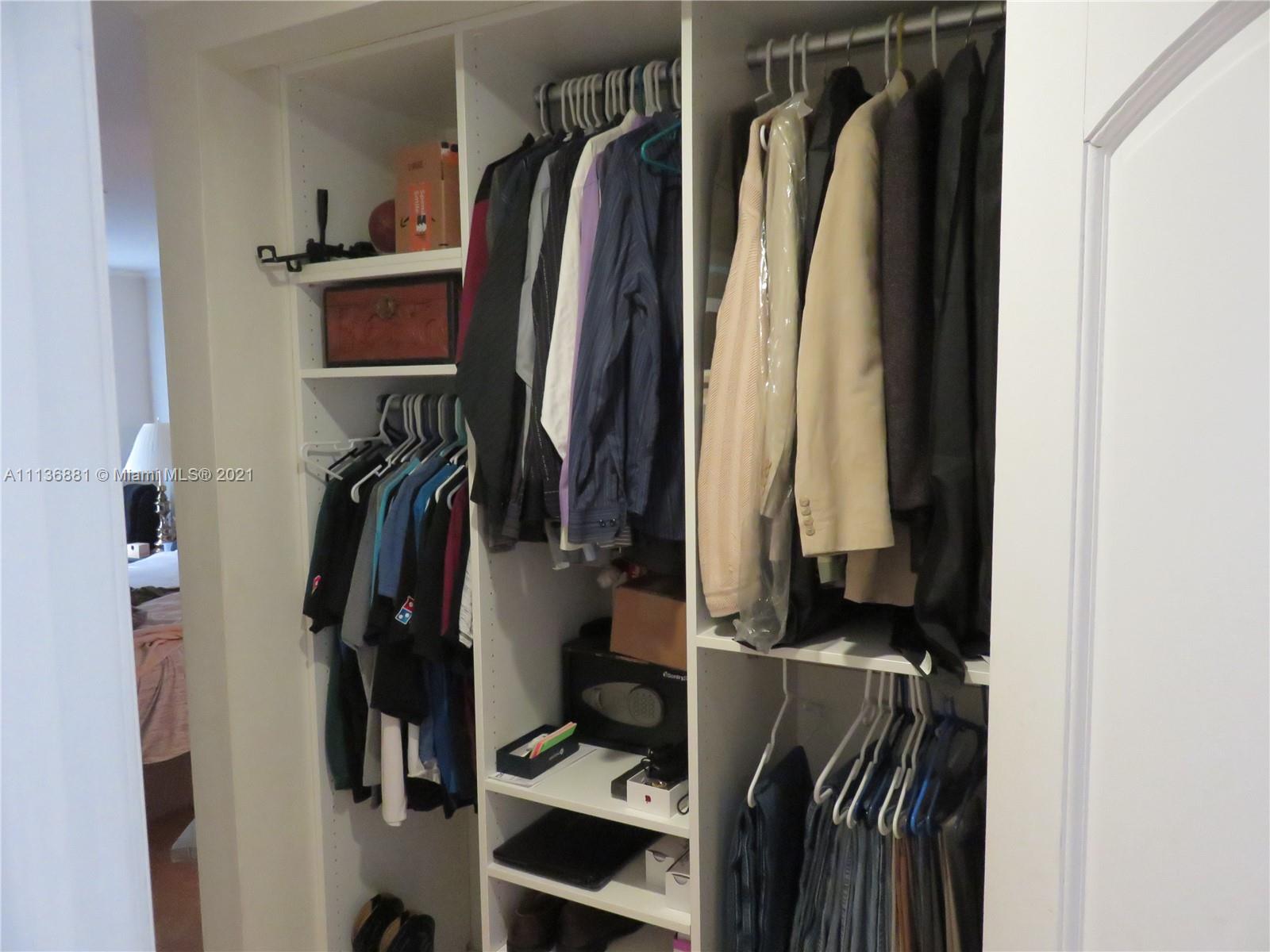 3237 Clint Moore Road, Unit 204 Boca Raton, FL 33496 - Photo 10 of 13 a view of walk in closet with clothes and shoes
