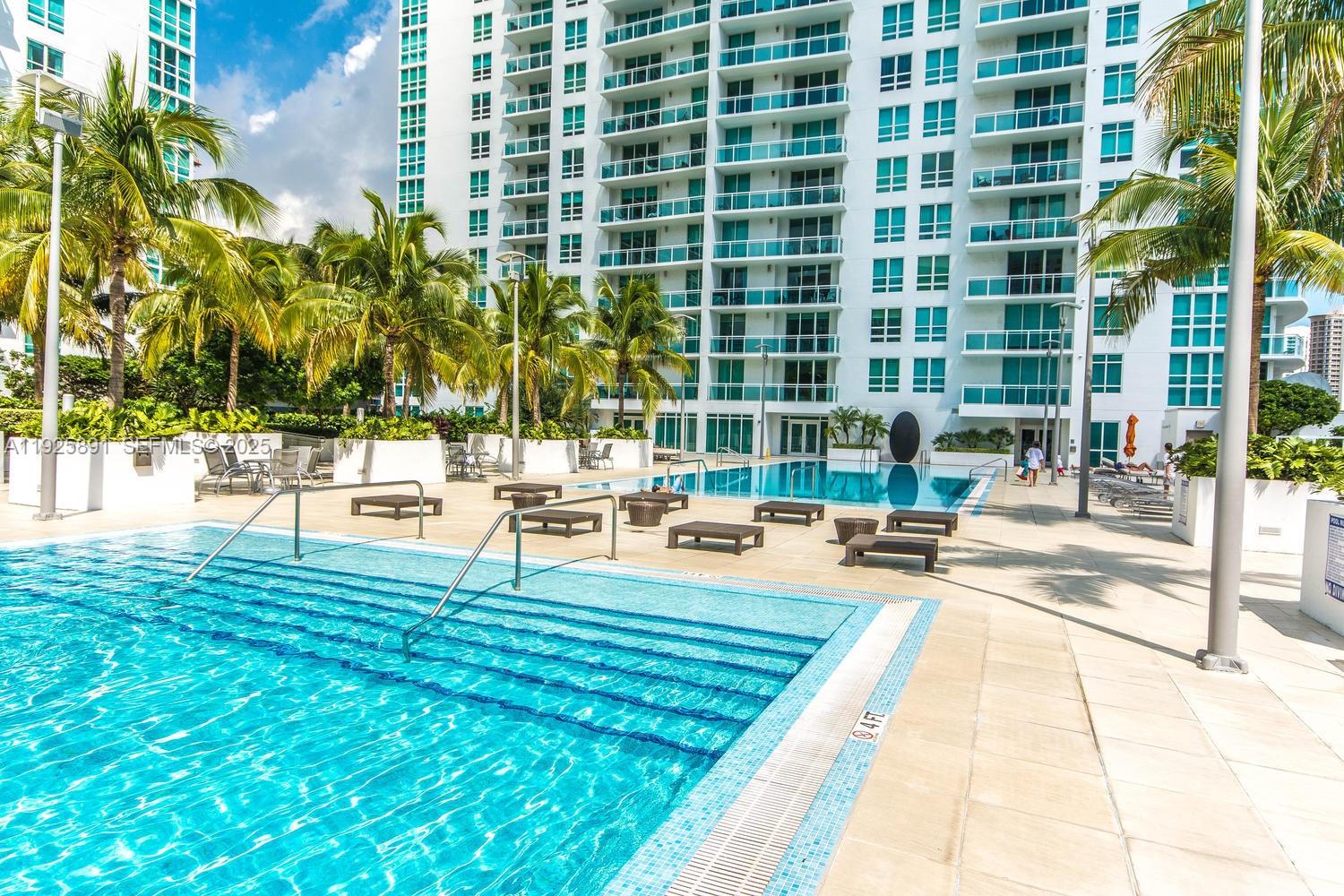 951 Brickell Avenue, Unit 1206 Miami, FL 33131 - Photo 11 of 12 a view of a swimming pool with a lounge chairs