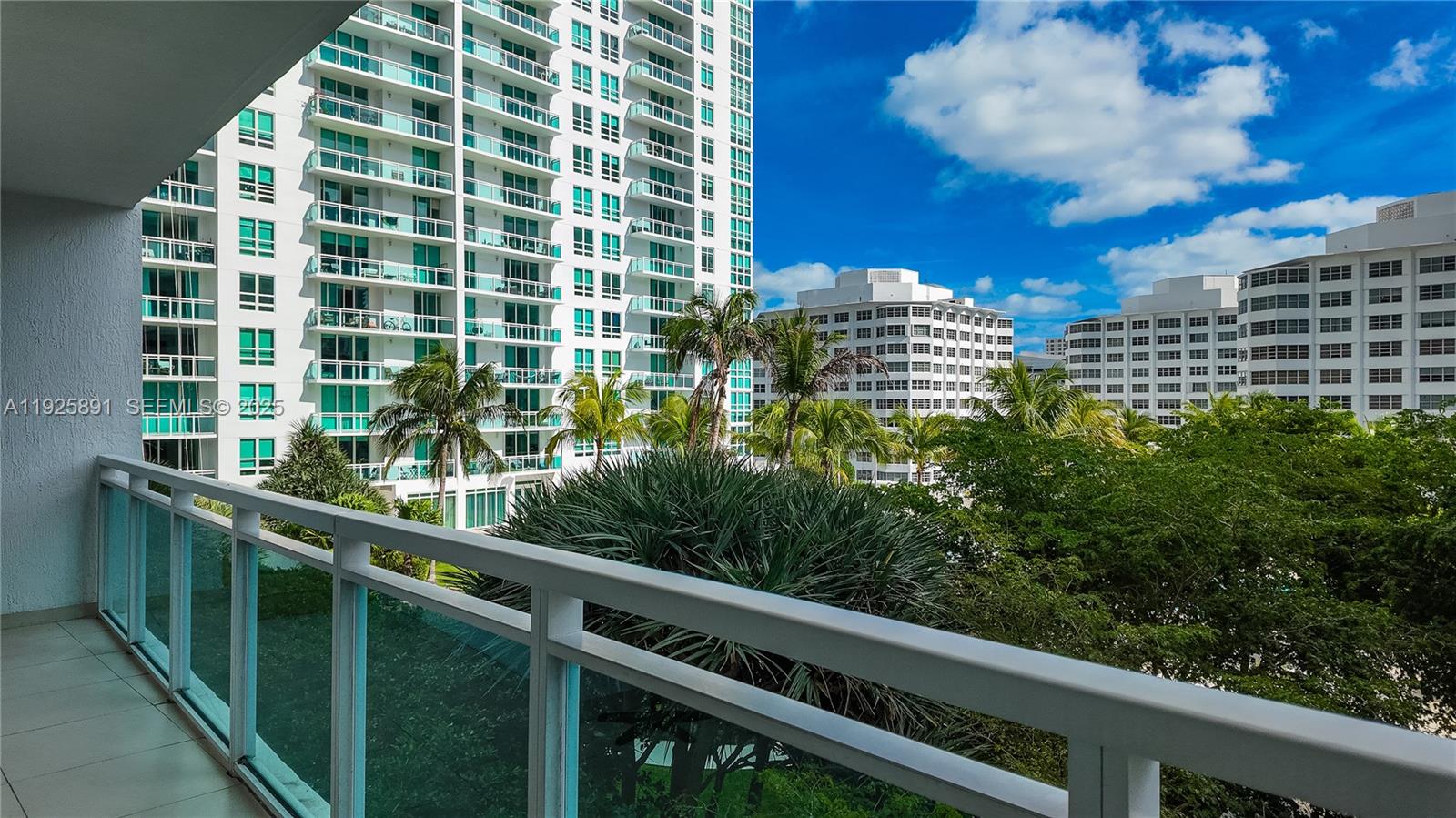 951 Brickell Avenue, Unit 1206 Miami, FL 33131 - Photo 12 of 12 a view of a balcony with a floor to ceiling window and wooden floor
