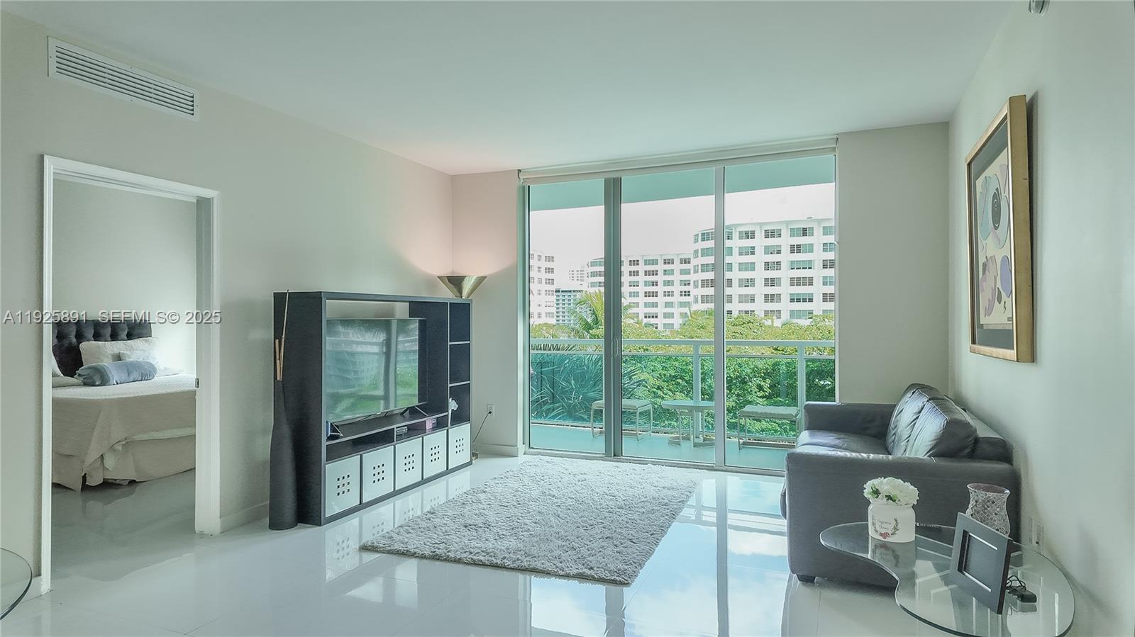 951 Brickell Avenue, Unit 1206 Miami, FL 33131 - Photo 4 of 12 a living room with furniture and a large window
