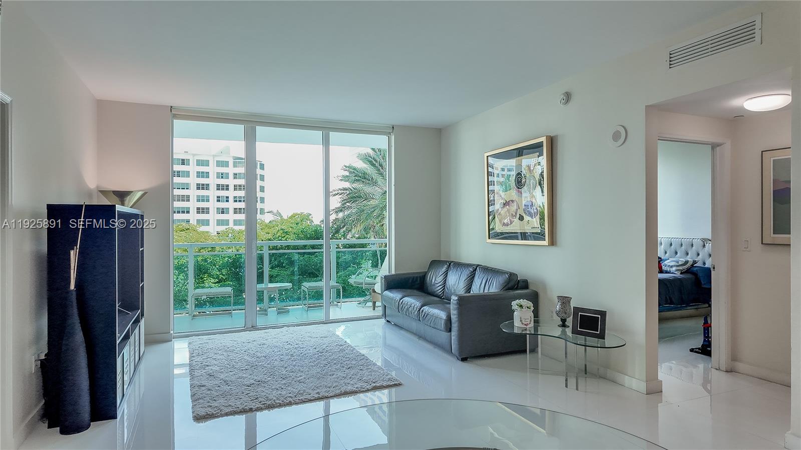 951 Brickell Avenue, Unit 1206 Miami, FL 33131 - Photo 7 of 12 a living room with furniture and a window