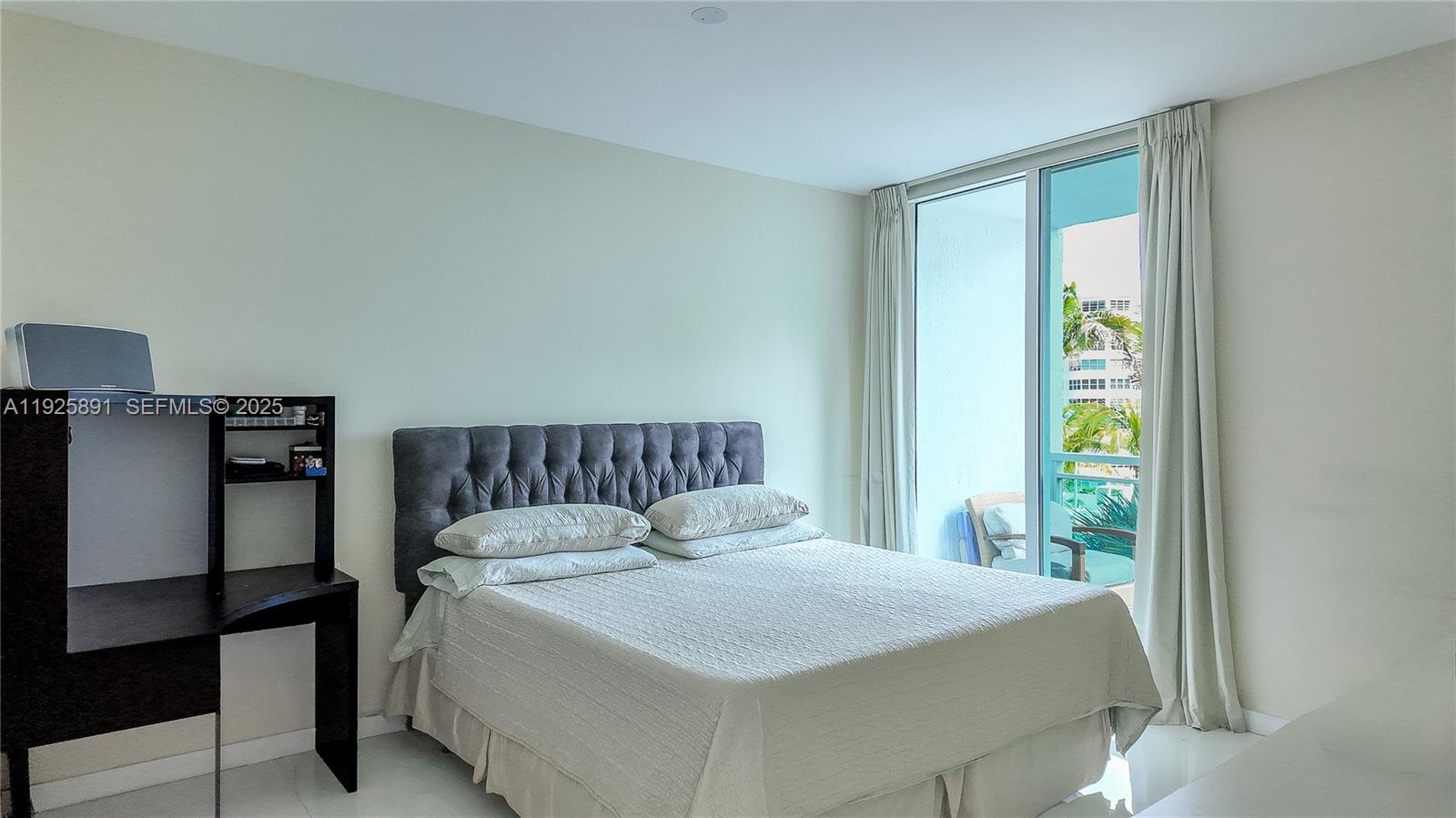951 Brickell Avenue, Unit 1206 Miami, FL 33131 - Photo 8 of 12 a bed sitting in a bedroom next to a window