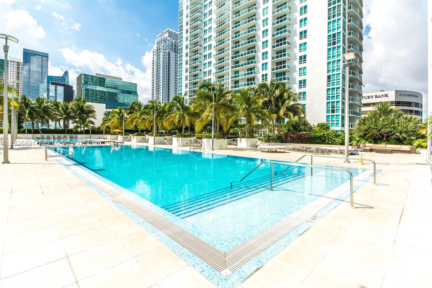 951 Brickell Avenue, Unit 1206 Miami, FL 33131 - Photo 10 of 12 a view of a swimming pool with a lawn chairs and a lawn chair
