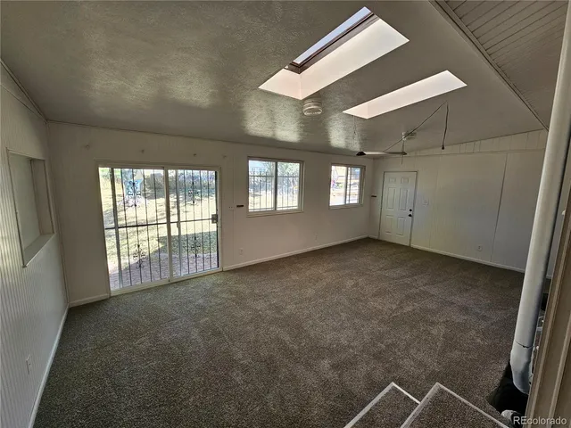 a view of an empty room with windows