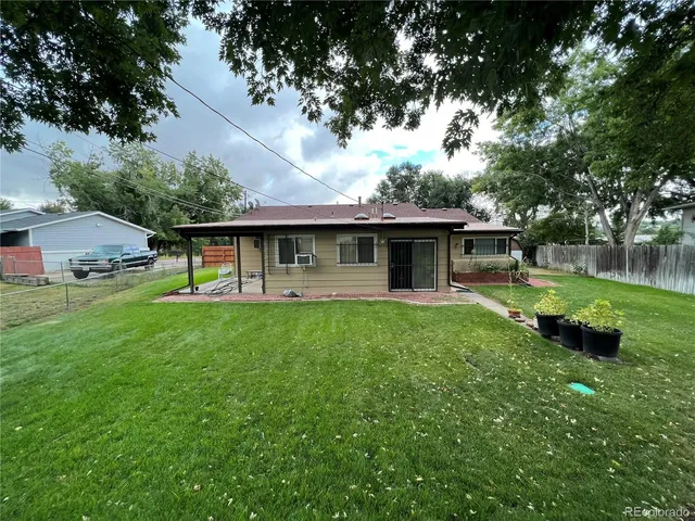 a view of a house with a backyard and a patio