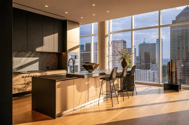 a kitchen with stainless steel appliances granite countertop a stove a sink and a microwave