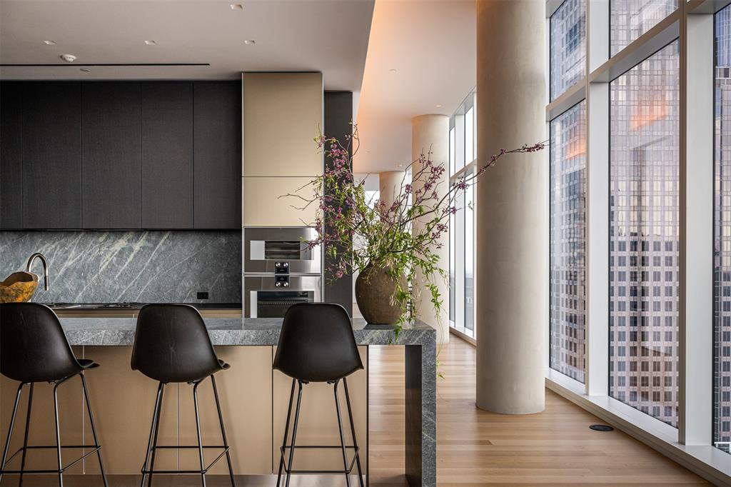 1747 Leonard Street, Unit 2601 Dallas, TX 75201 - Photo 2 of 33 a kitchen with a table and chairs