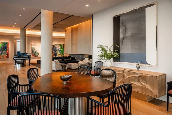 a dining room with furniture a window and wooden floor