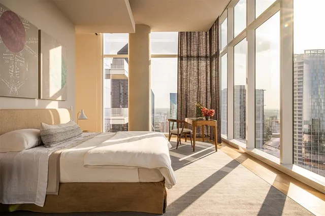 a bedroom with a bed and a large window