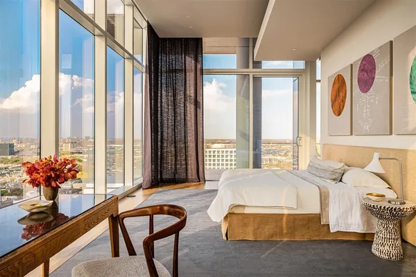 a spacious bedroom with a bed and a large window