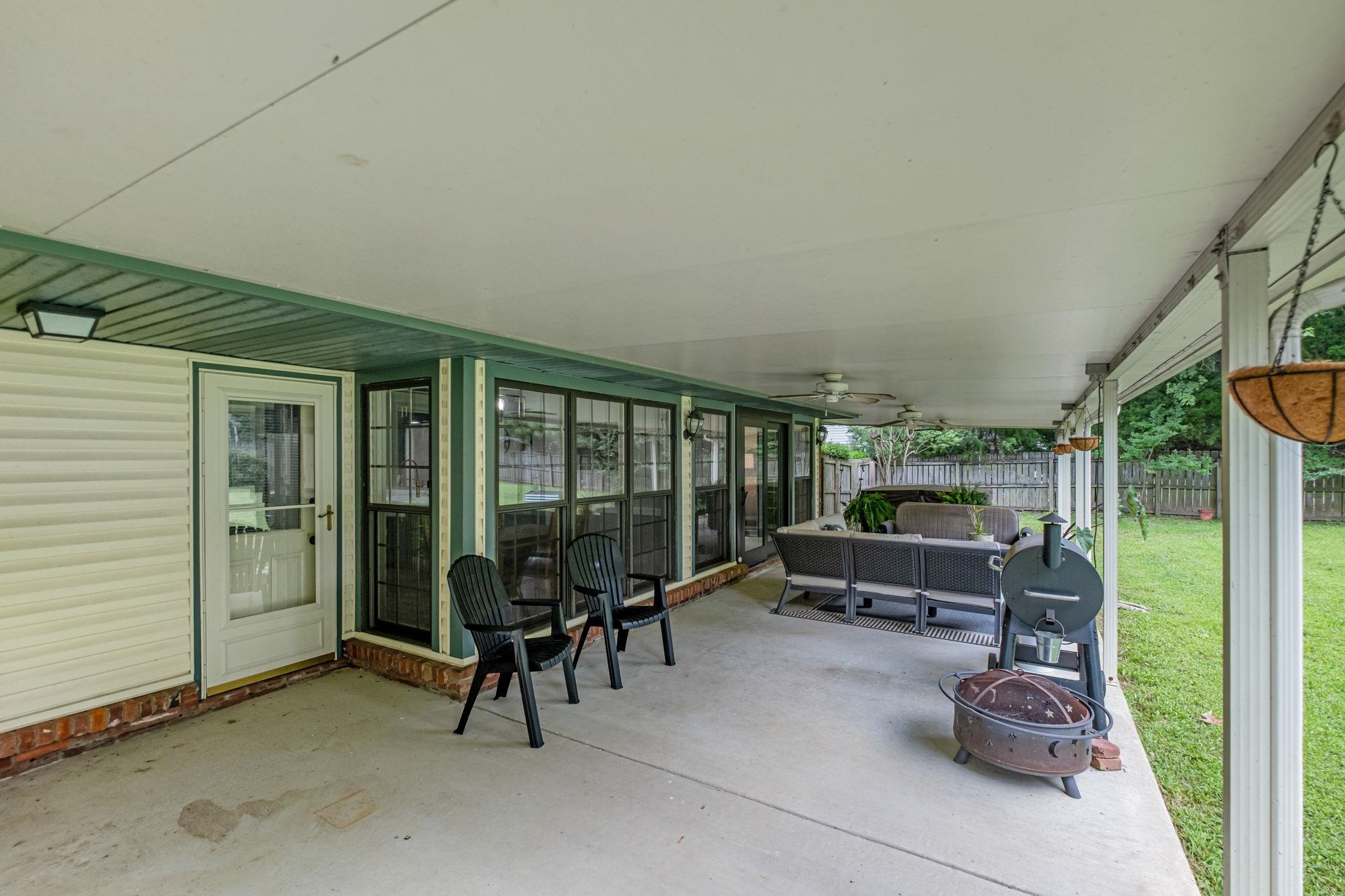 4729 Cedar Ridge Drive Millington, TN 38053 - Photo 35 of 40 Expansive covered patio featuring a concrete surface, white vinyl siding, a painted ceiling, and multiple ceiling fans