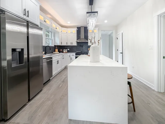 a kitchen with stainless steel appliances a refrigerator sink and microwave