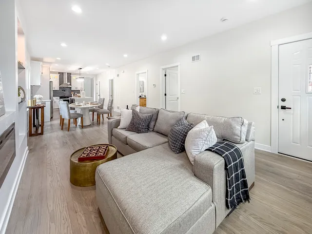 a living room with furniture and a wooden floor