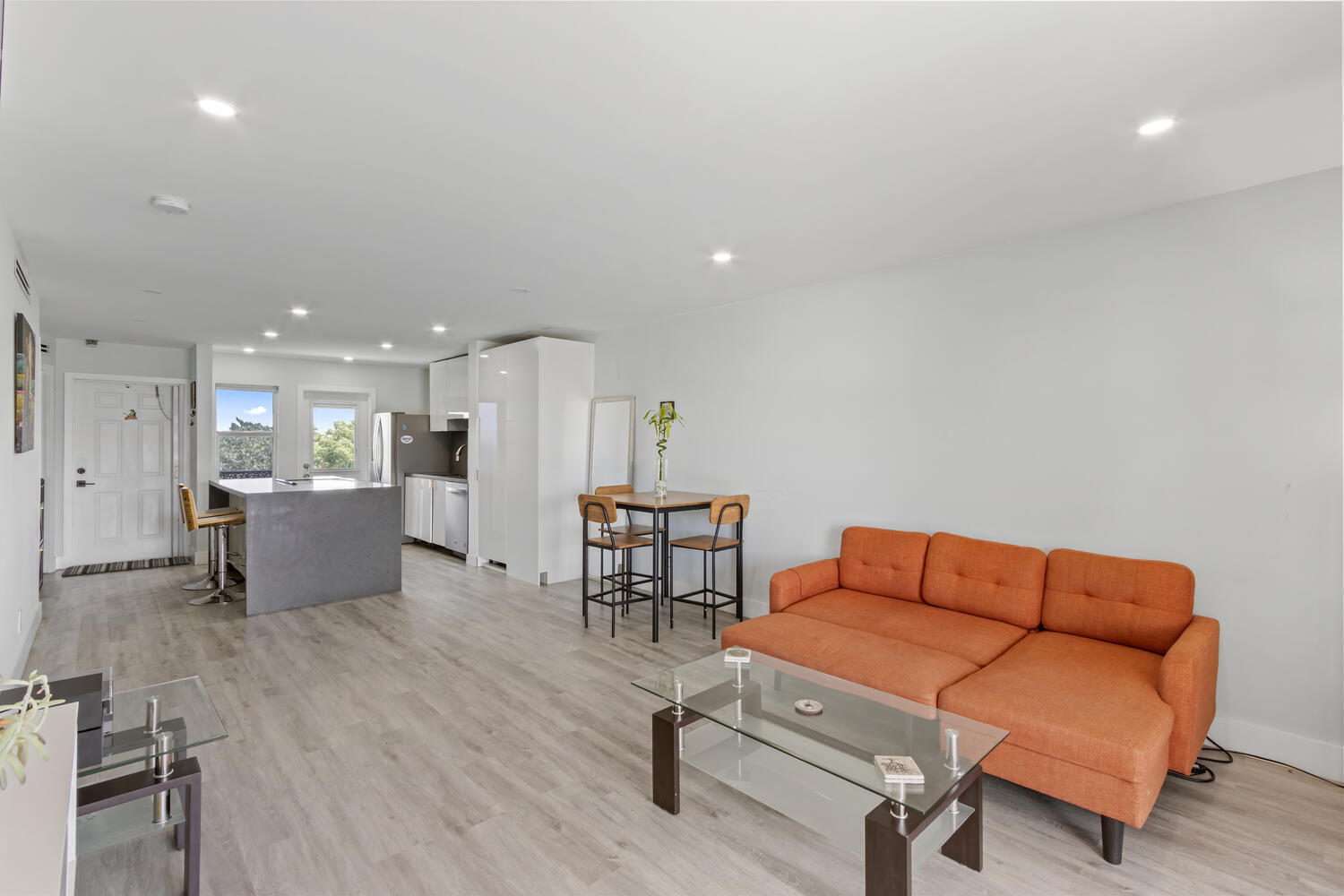 2871 North Ocean Boulevard, Unit V443 Boca Raton, FL 33431 - Photo 18 of 49 a living room with furniture and a dining table with wooden floor