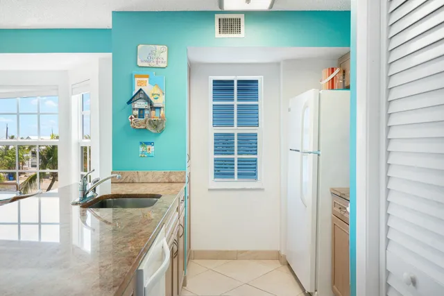 a bathroom with a granite countertop sink mirror and a bath tub