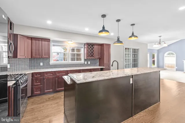 a view of an empty room with a fireplace and a window