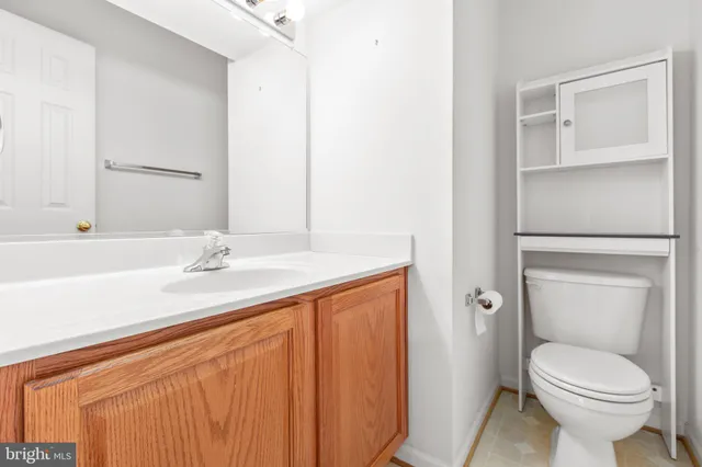 an empty room with a chandelier fan and closet area