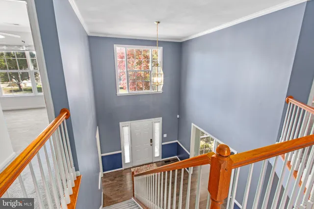 an empty room with closet and a ceiling fan
