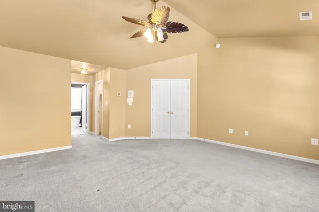 a big room with closet and windows