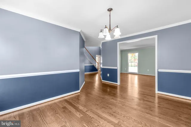 a view of an entryway with wooden floor and stairs