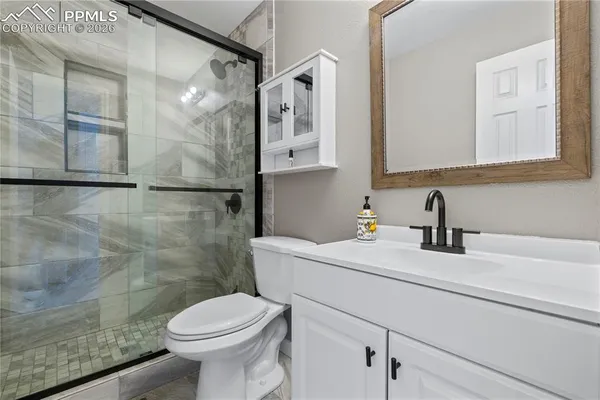 a bathroom with a sink a toilet and a mirror