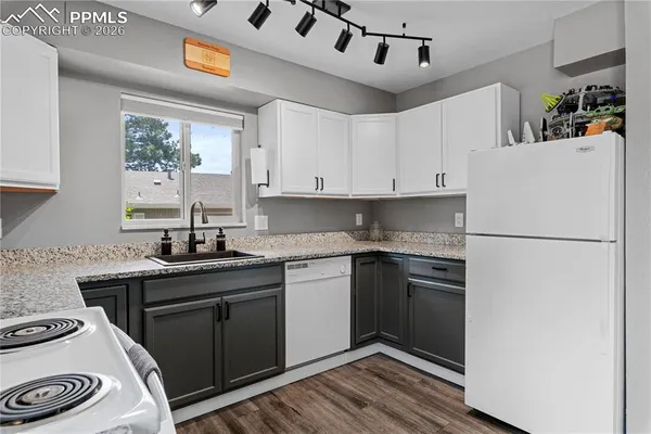 a kitchen with a refrigerator and a sink