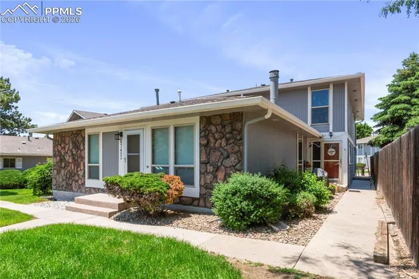 a view of a house with a yard and plants