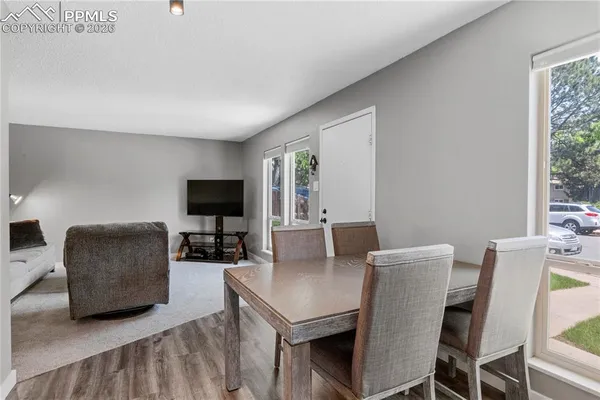 a living room with furniture a flat screen tv and a large window