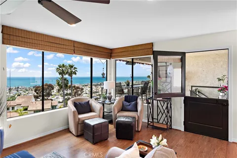a living room with furniture and a floor to ceiling window