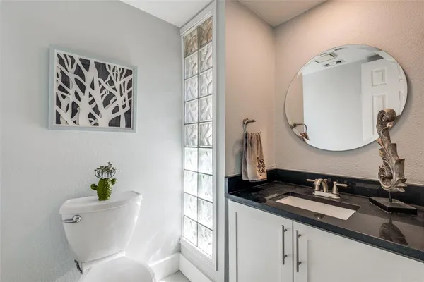 a bathroom with a toilet a sink and a mirror