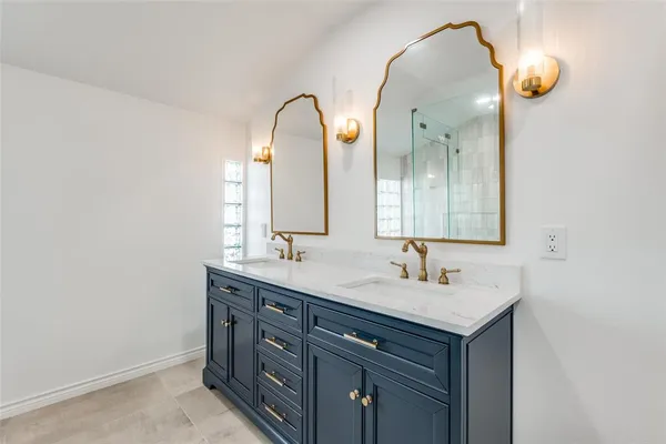a bathroom with a double vanity sink and a mirror
