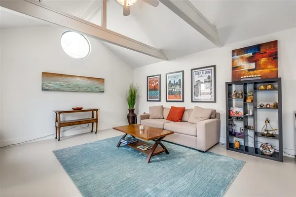 a living room with furniture and a painting on the wall
