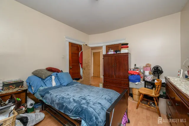 a bedroom with furniture and a wooden floor