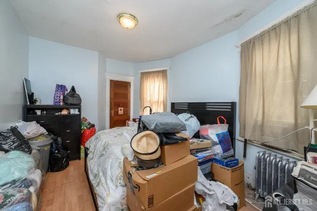 a bedroom with bed and a window