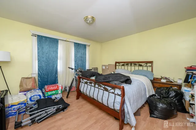 a bedroom with furniture and a wooden floor