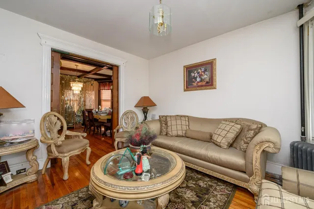 a living room with furniture and a chandelier