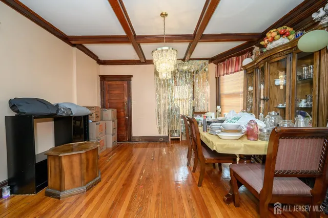 a dining room with furniture and wooden floor