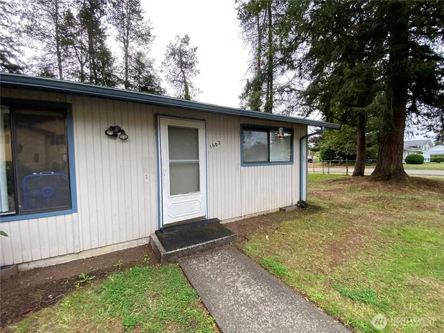 a side view of a house with a yard