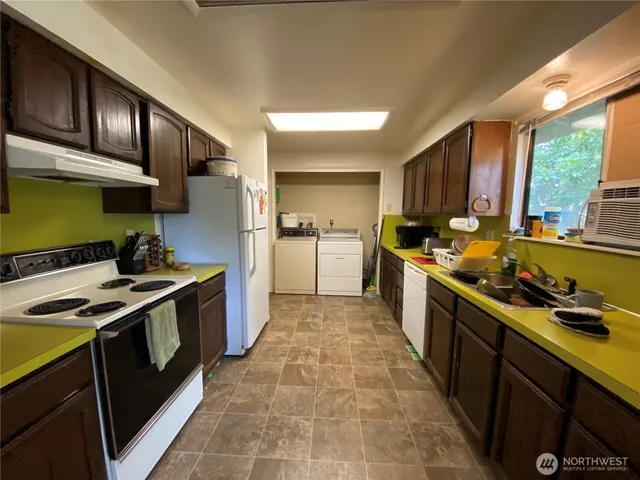 a kitchen with stainless steel appliances a stove a sink and a refrigerator