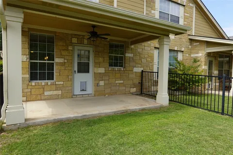a view of front door of house with green space