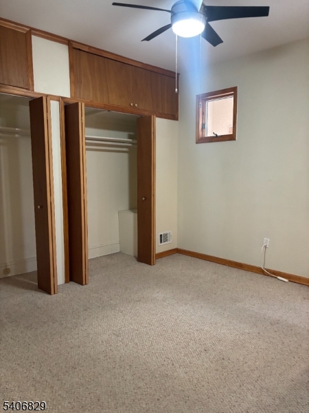 21 Main Street Linden, NJ 07036 - Photo 13 of 19 an empty room with closet and a chandelier fan