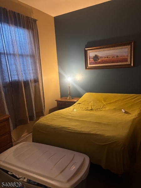 21 Main Street Linden, NJ 07036 - Photo 18 of 19 a bedroom with a bed and wooden floor