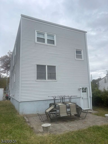 21 Main Street Linden, NJ 07036 - Photo 2 of 19 a backyard of a house with table and chairs
