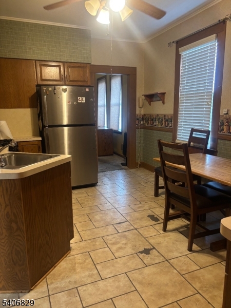 21 Main Street Linden, NJ 07036 - Photo 6 of 19 a kitchen with a refrigerator and a table in it
