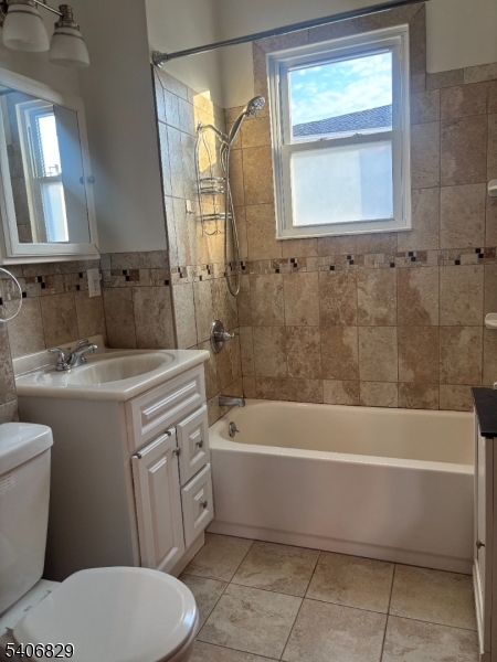 21 Main Street Linden, NJ 07036 - Photo 8 of 19 a bathroom with a sink a toilet and a bathtub