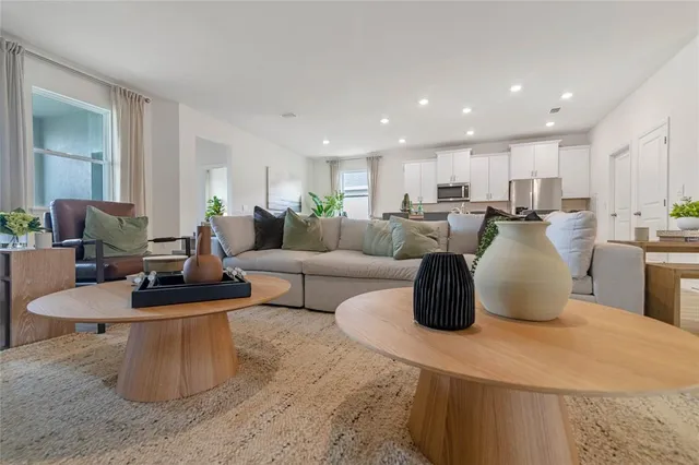 a living room with furniture and kitchen view