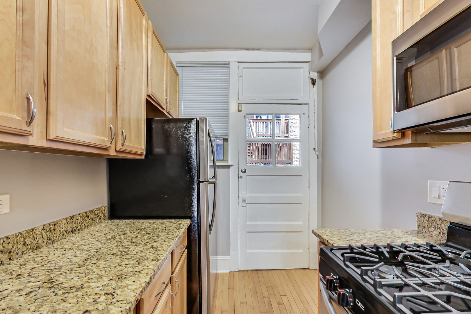 932 Pleasant Street, Unit 2W Oak Park, IL 60302 - Photo 11 of 21 a kitchen with stainless steel appliances granite countertop a refrigerator and a stove top oven