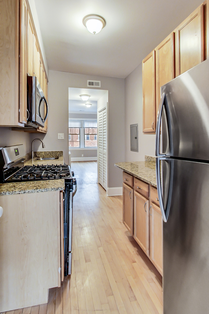 932 Pleasant Street, Unit 2W Oak Park, IL 60302 - Photo 12 of 21 a kitchen with stainless steel appliances granite countertop a refrigerator a stove and a sink