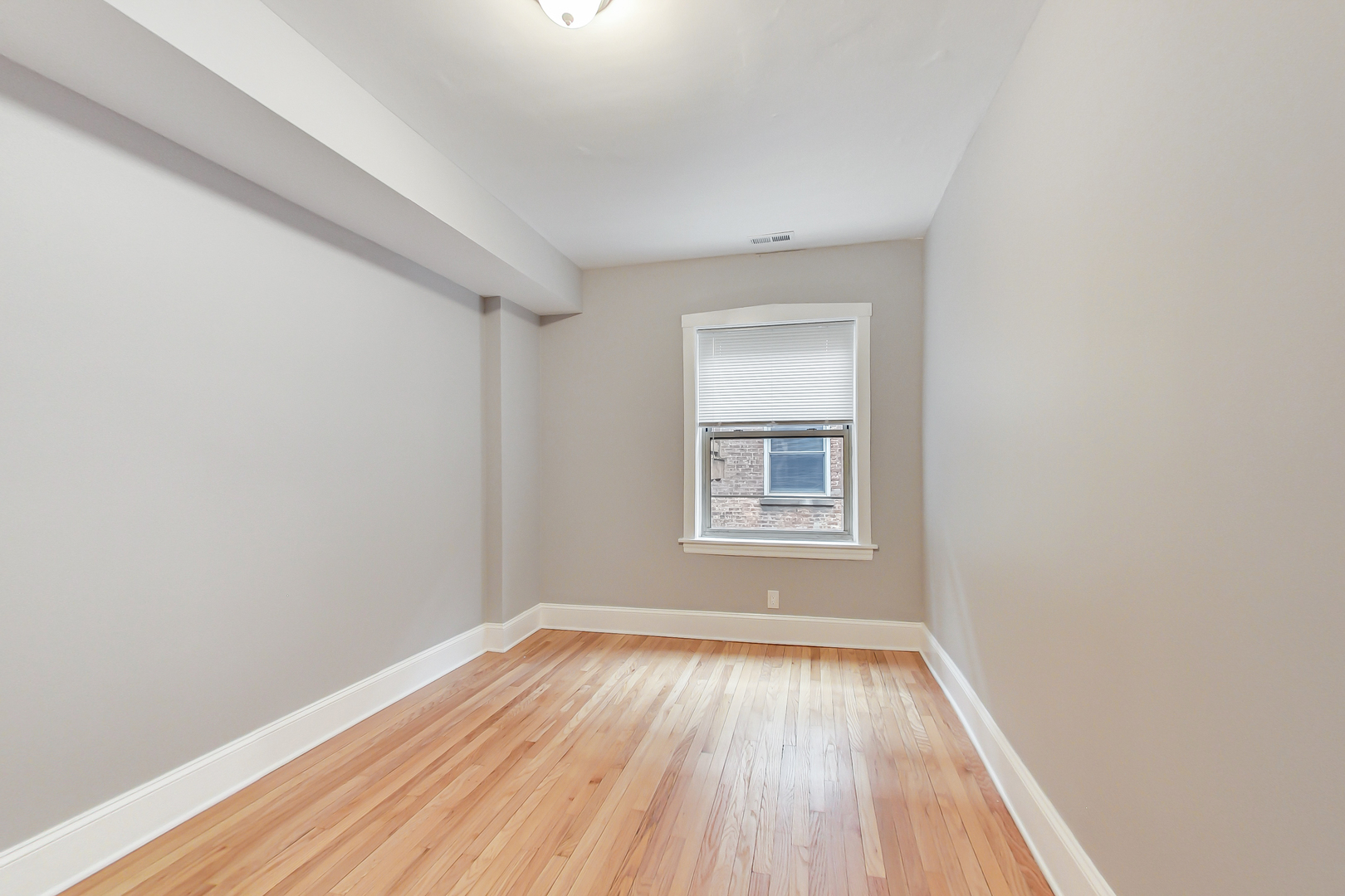 932 Pleasant Street, Unit 2W Oak Park, IL 60302 - Photo 14 of 21 an empty room with wooden floor and windows