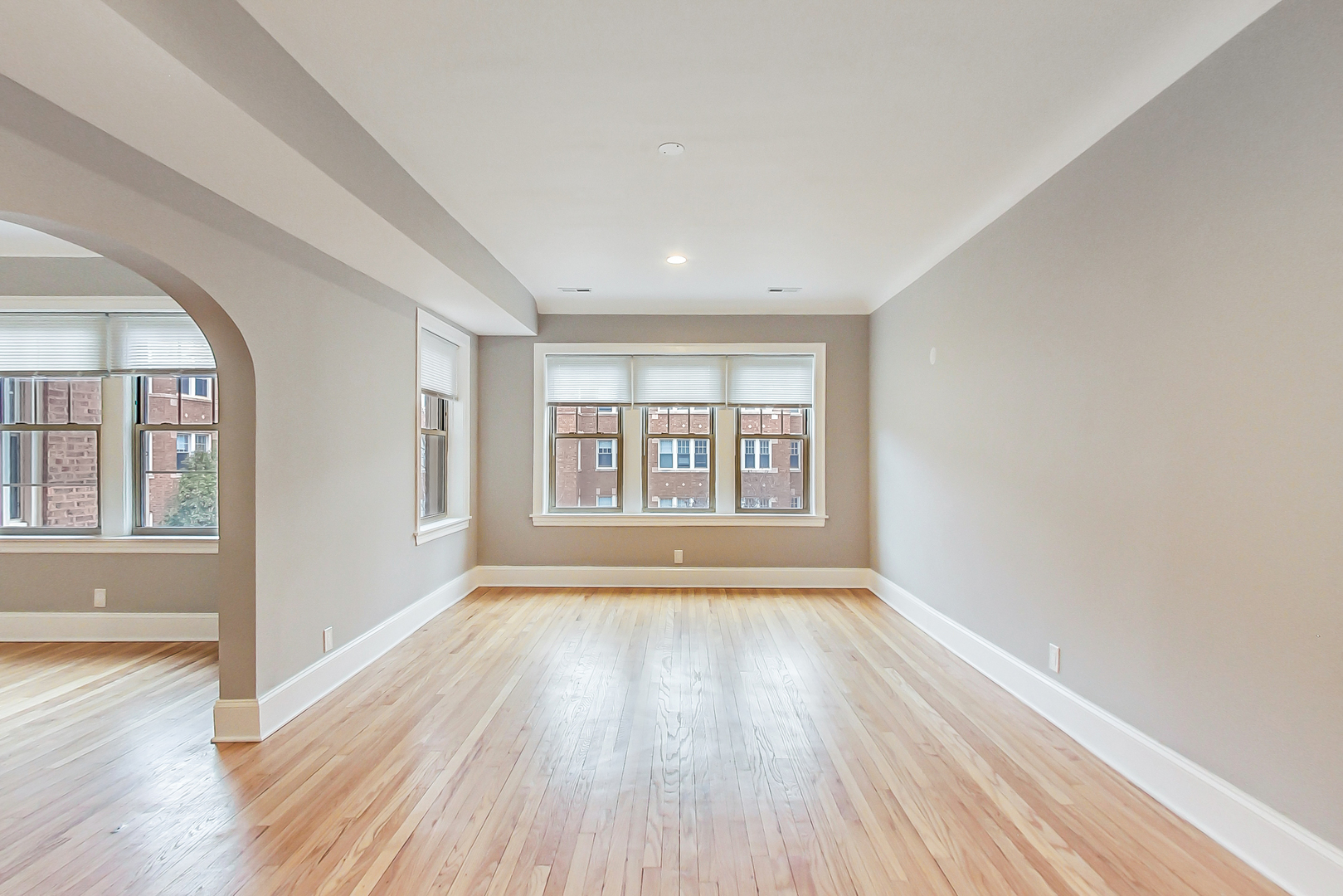 932 Pleasant Street, Unit 2W Oak Park, IL 60302 - Photo 5 of 21 a view of an empty room with wooden floor and a window